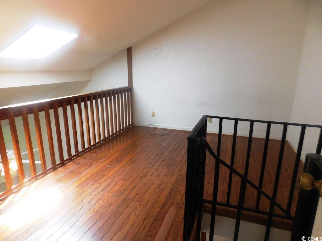 1202 Tiffany Lane, Unit D Myrtle Beach, SC 29577 - Photo 14 of 21 Hall with hardwood / wood-style floors and an upstairs landing