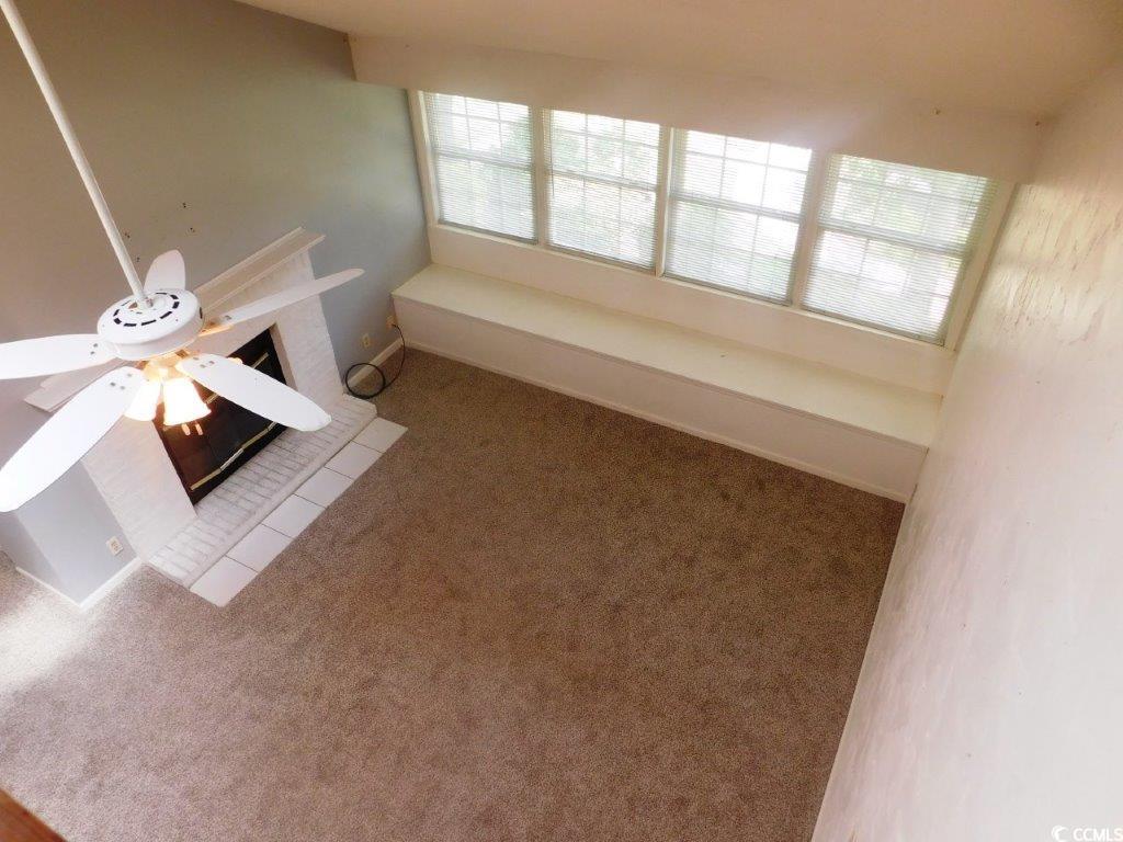 1202 Tiffany Lane, Unit D Myrtle Beach, SC 29577 - Photo 17 of 21 Unfurnished living room with healthy amount of natural light, carpet flooring, and ceiling fan