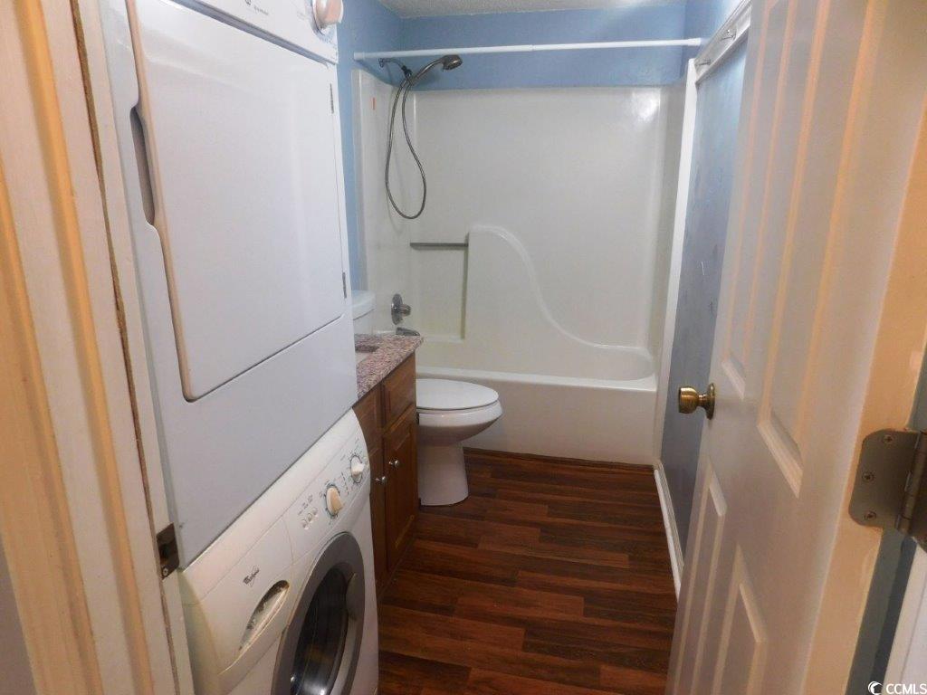 1202 Tiffany Lane, Unit D Myrtle Beach, SC 29577 - Photo 6 of 21 Full bath featuring stacked washer / dryer, wood finished floors, tub / shower combination, and vanity
