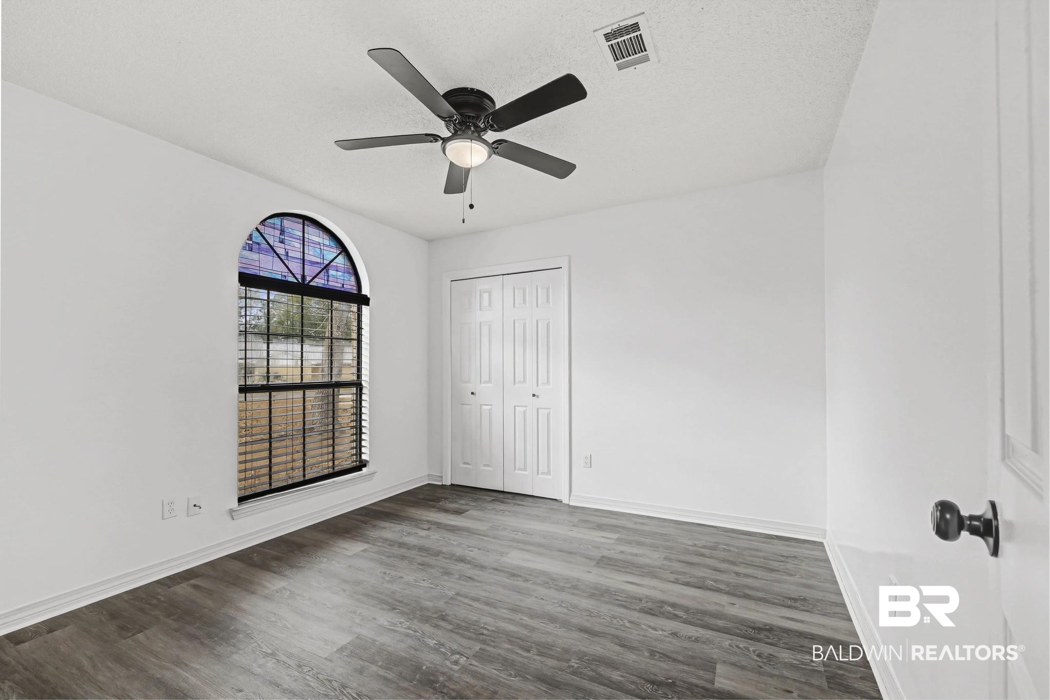 2776 Santa Rosa Circle Lillian, AL 36549 - Photo 26 of 48 Unfurnished bedroom with wood finished floors, a ceiling fan, a closet, and a textured ceiling
