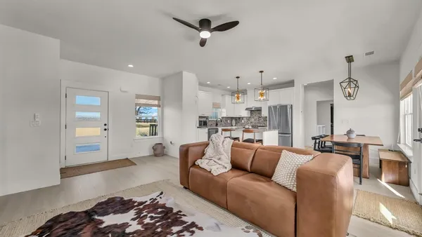 a living room with furniture and a chandelier