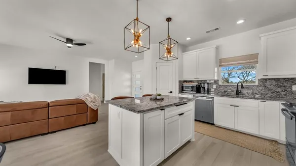 a kitchen with stainless steel appliances granite countertop a sink and cabinets