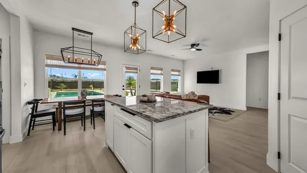 a kitchen with a counter space a sink appliances and a window