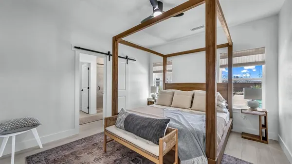 a bedroom with a bed window and a glass door