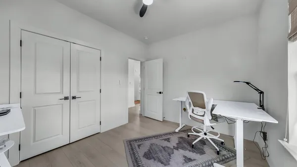 a workspace room with furniture and wooden floor