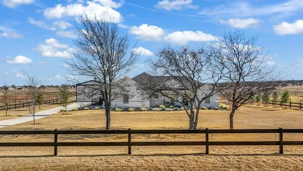 a view of a yard with wooden fence