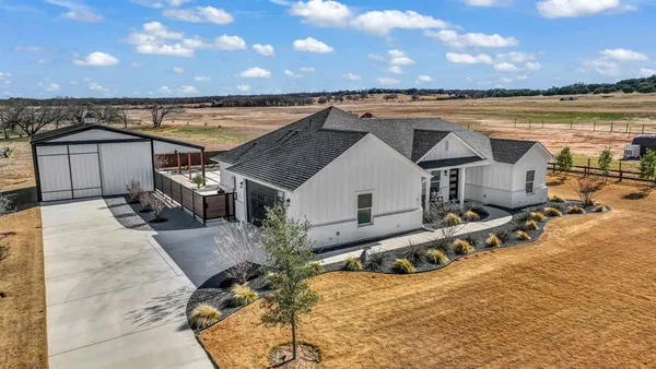 an aerial view of a house with a patio