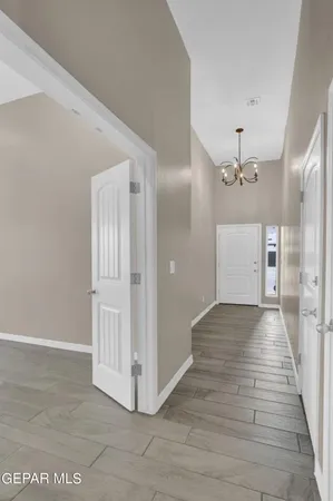 a view of a hallway with wooden floor