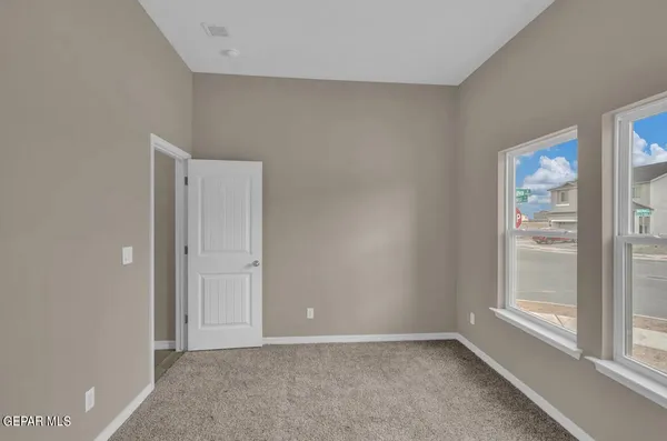 a view of an empty room with a window