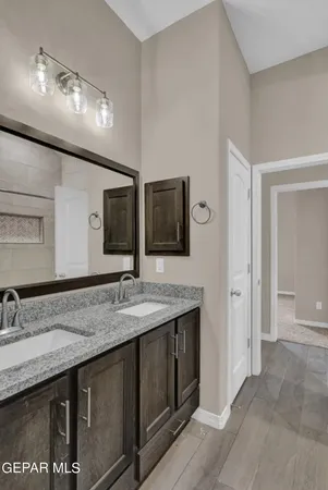 a bathroom with double sink and a mirror