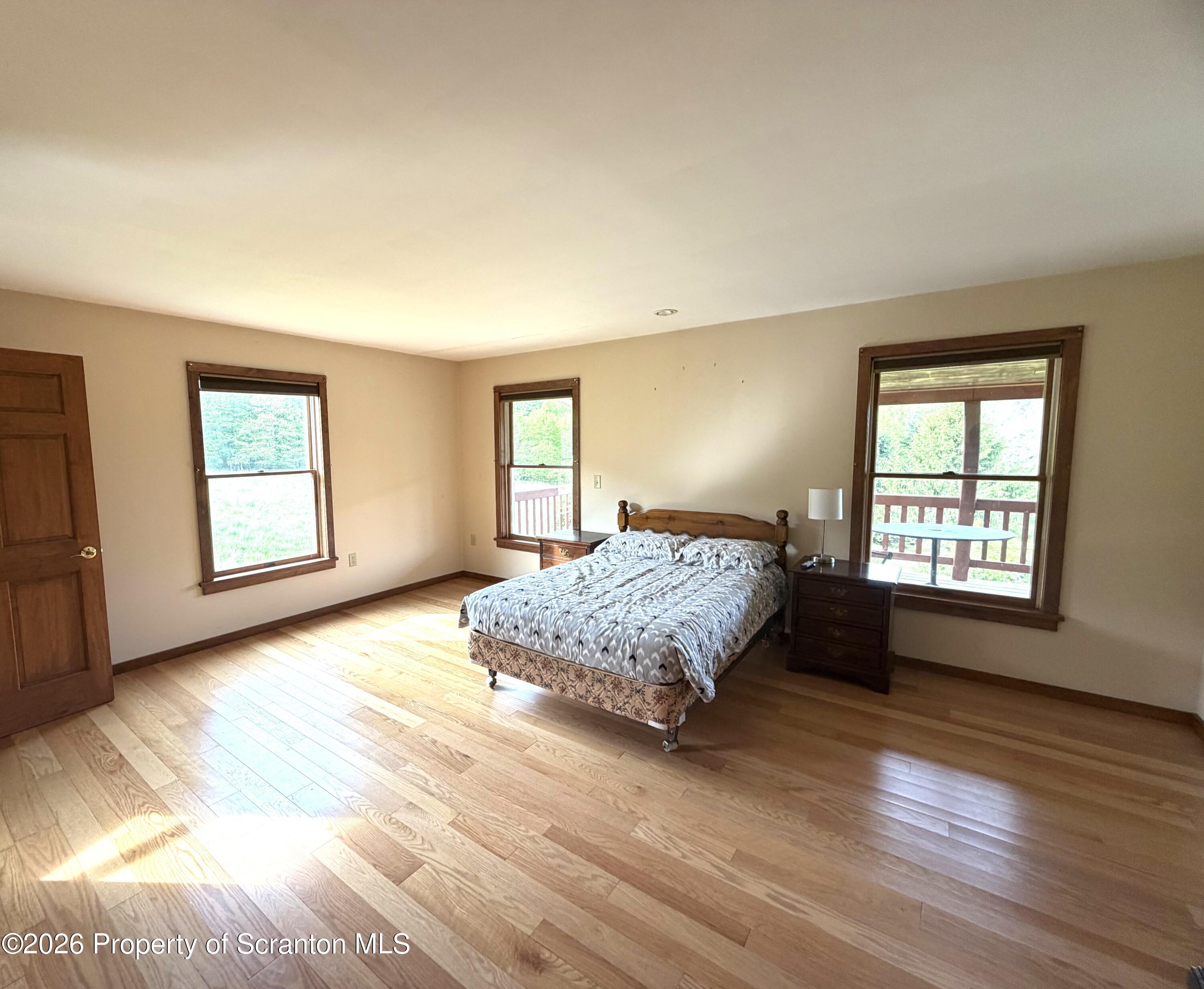 5290 Irish Hill Road Montrose, PA 18801 - Photo 33 of 67 a living room with a bed furniture and a window