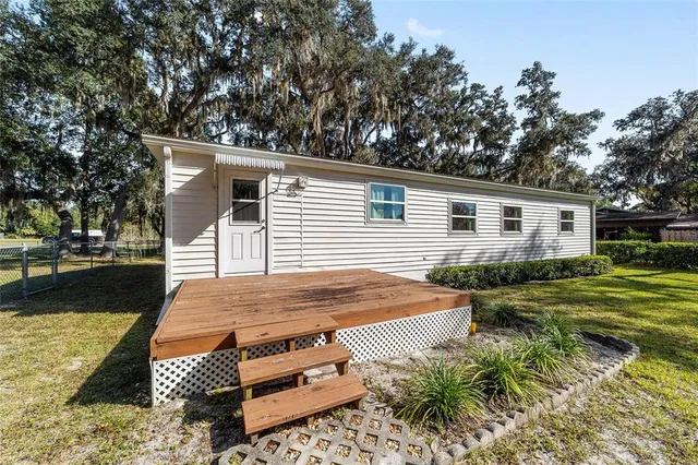 a view of a house with swimming pool and sitting area