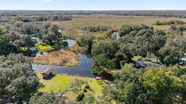 an aerial view of a houses with a yard