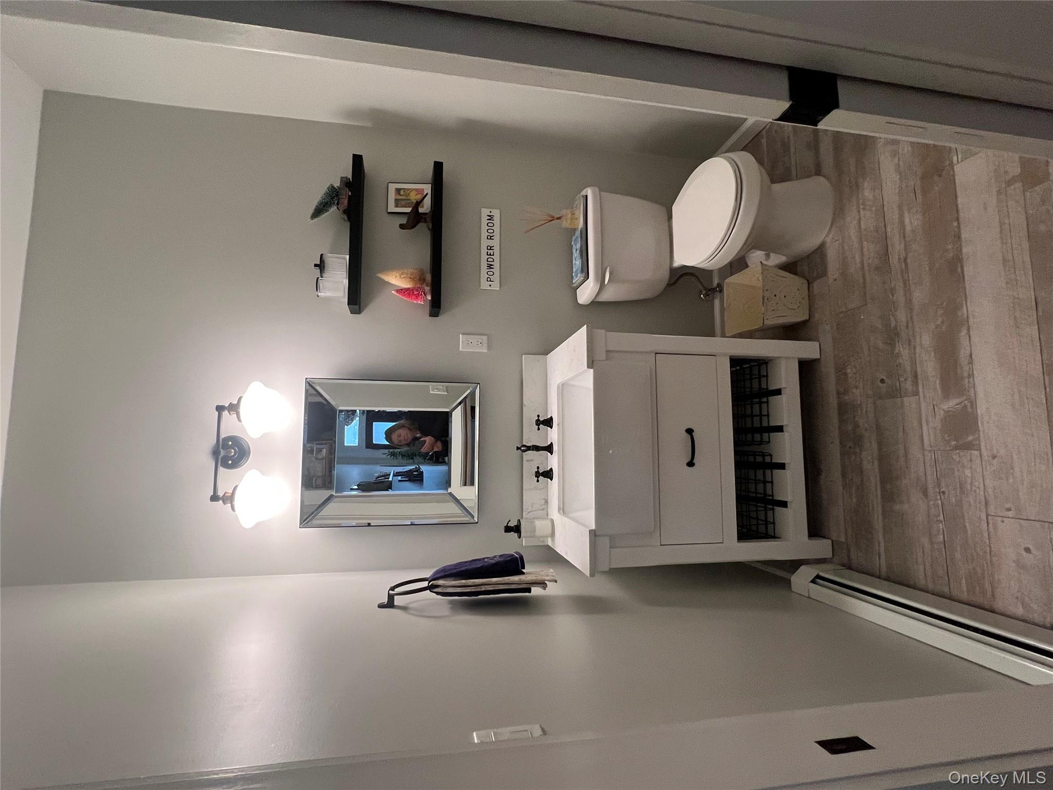 103 Filors Lane, Unit 101 Stony Point, NY 10980 - Photo 12 of 23 a bathroom with a sink a toilet and a mirror