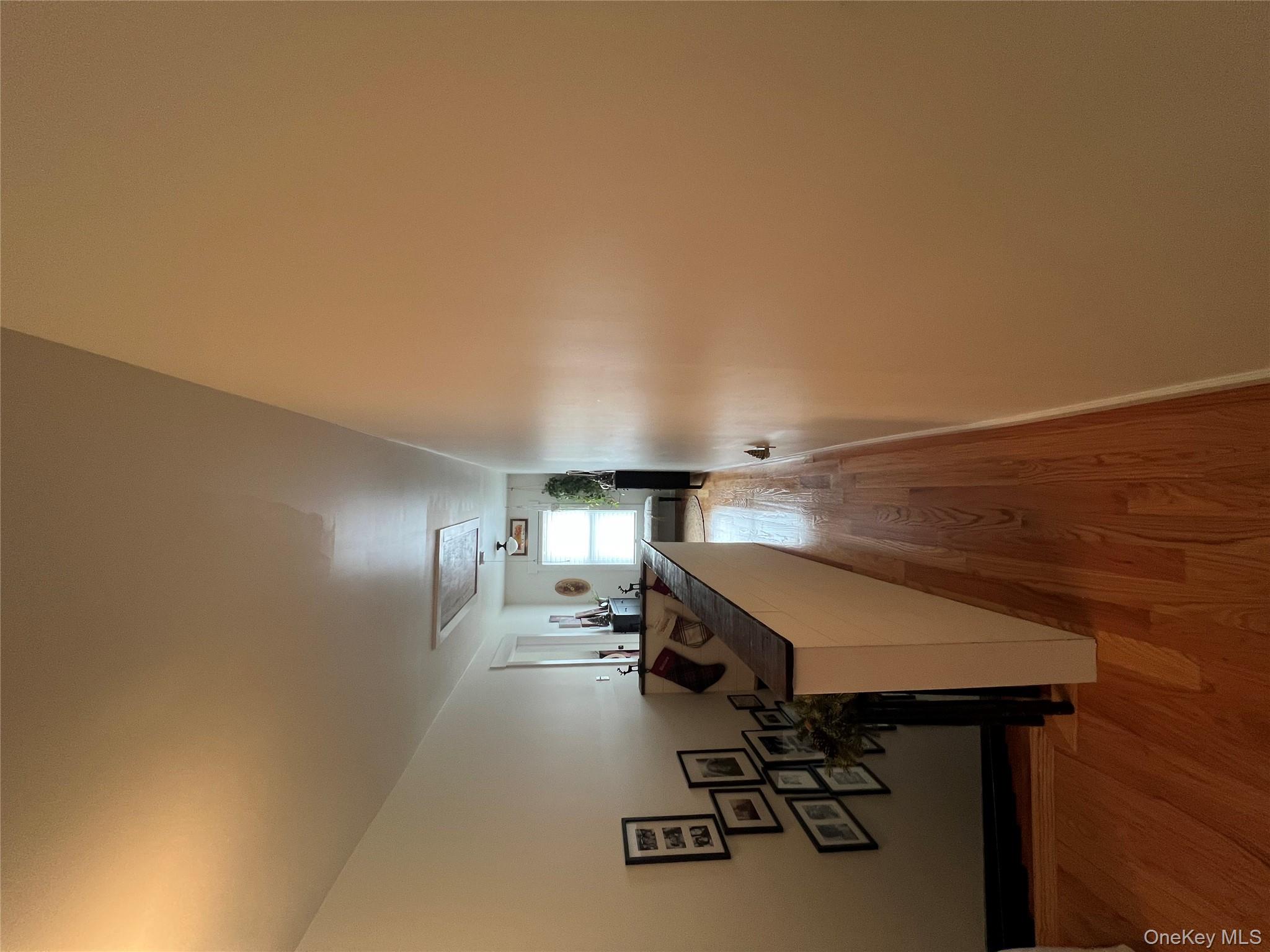 103 Filors Lane, Unit 101 Stony Point, NY 10980 - Photo 15 of 23 a view of a hallway with wooden floor and a potted plant
