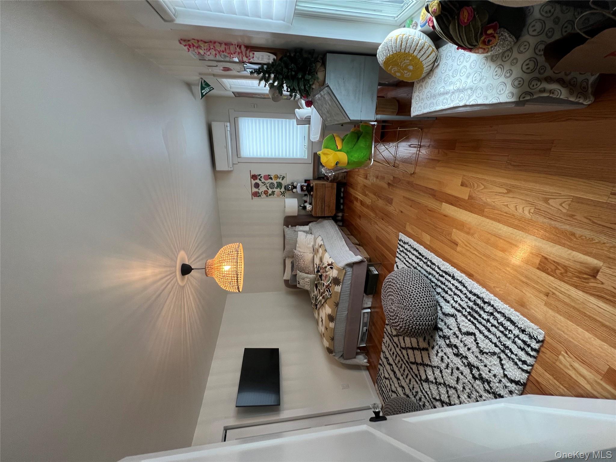 103 Filors Lane, Unit 101 Stony Point, NY 10980 - Photo 20 of 23 a living room with furniture and a wooden floor