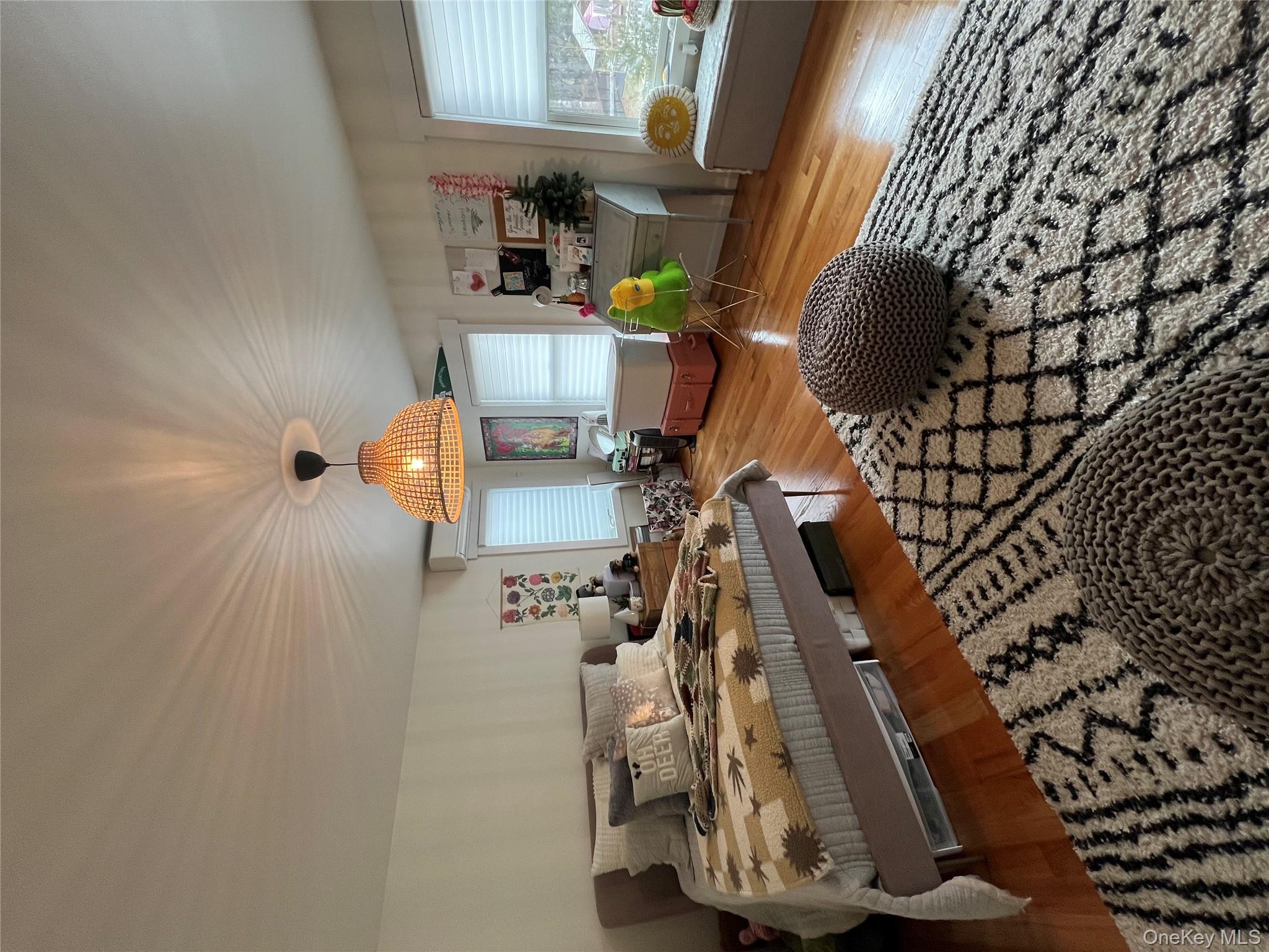 103 Filors Lane, Unit 101 Stony Point, NY 10980 - Photo 21 of 23 a bedroom with a bed and a chandelier