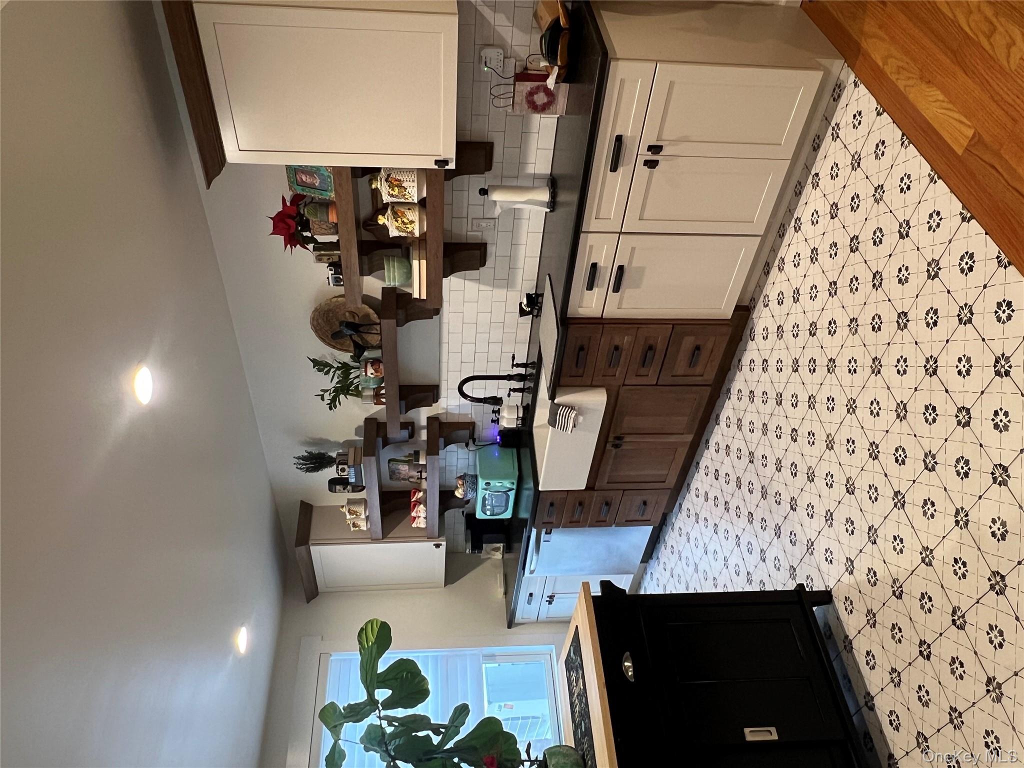 103 Filors Lane, Unit 101 Stony Point, NY 10980 - Photo 7 of 23 a kitchen with stainless steel appliances kitchen island granite countertop a sink and cabinets