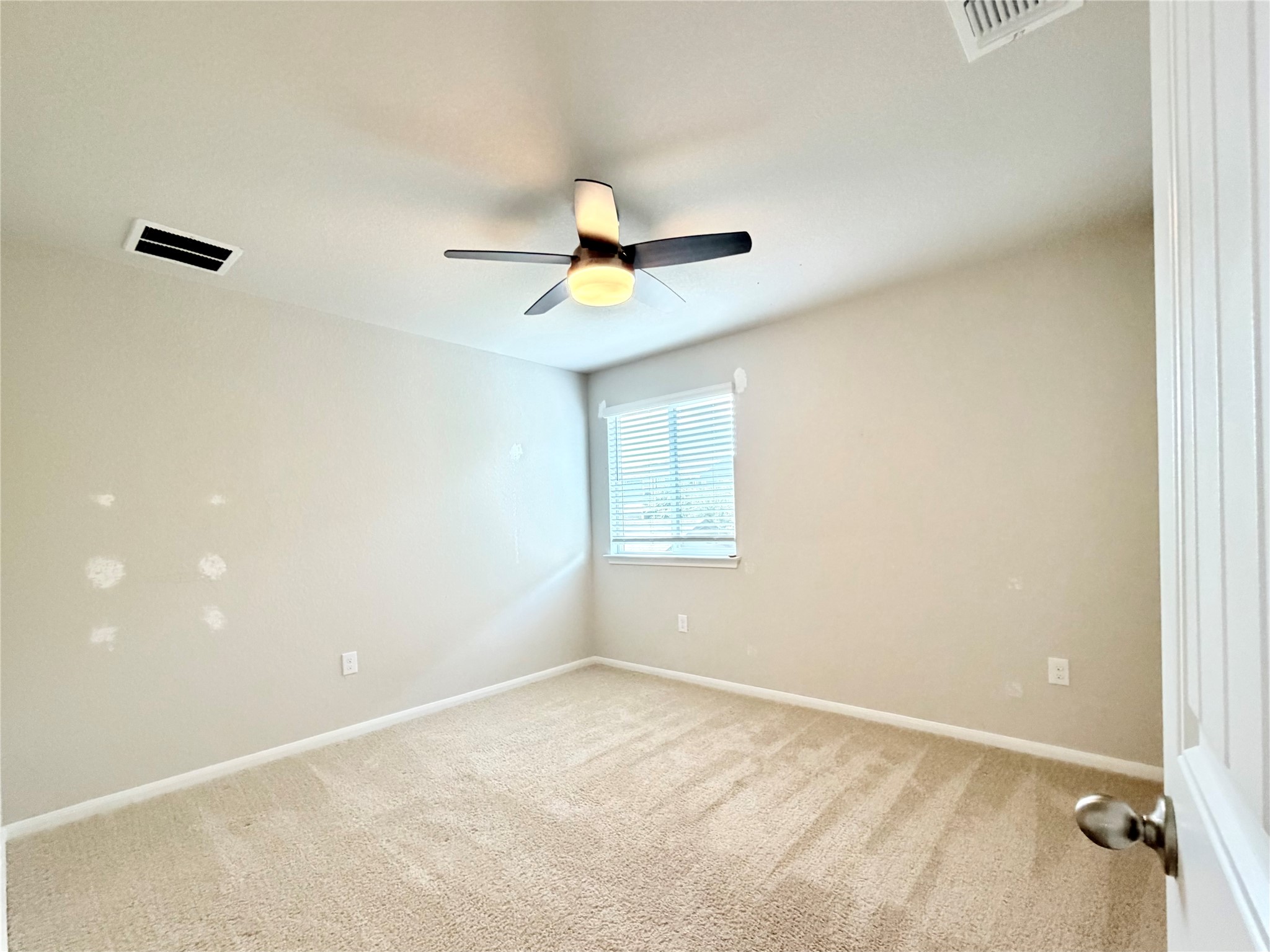 10502 Fulton Avenue Austin, TX 78754 - Photo 23 of 36 A well-lit room featuring neutral carpet and a window for natural light.