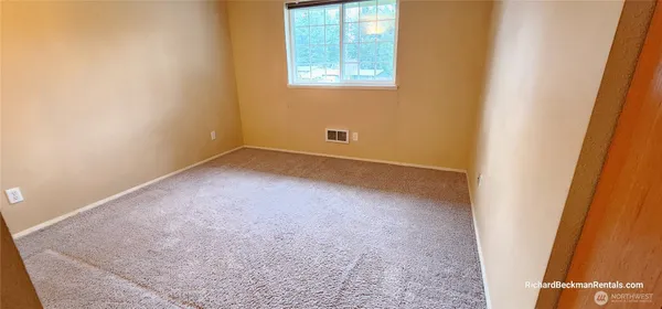 a bathroom with a granite countertop toilet and a shower