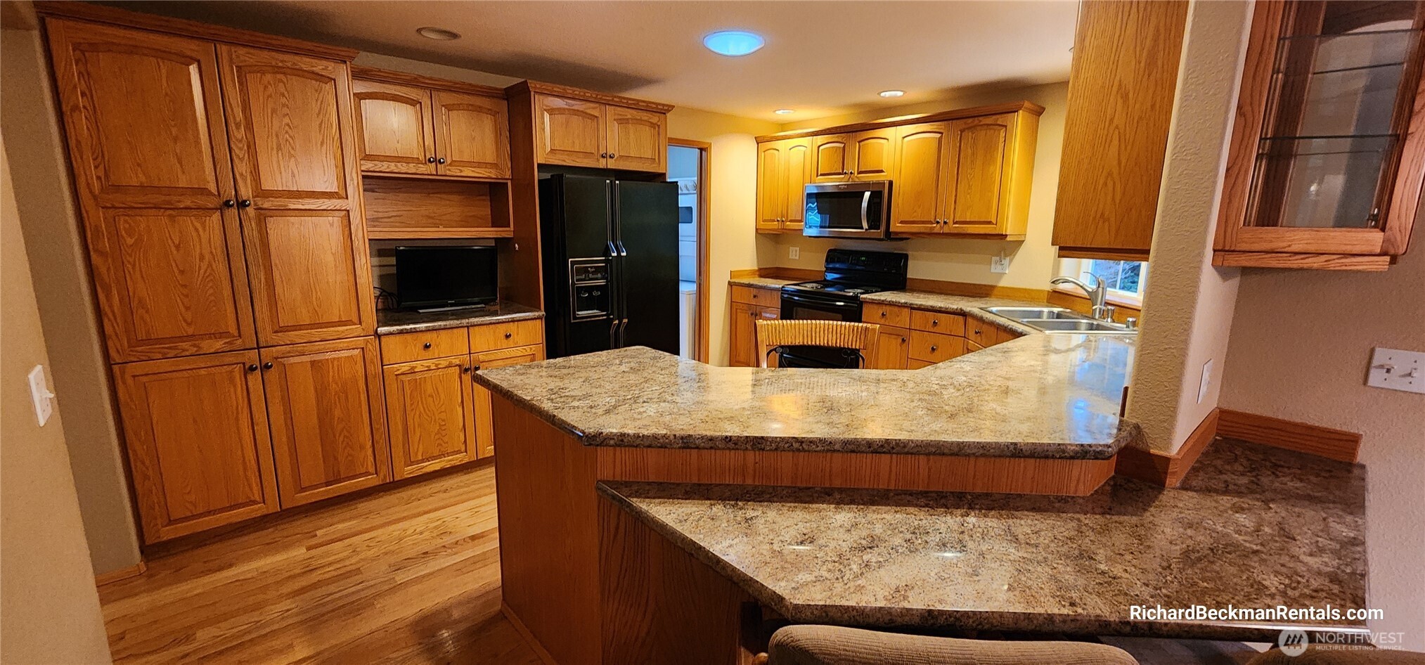 701 East Rd Of Tralee Shelton, WA 98584 - Photo 3 of 20 a kitchen with granite countertop wooden cabinets and stainless steel appliances