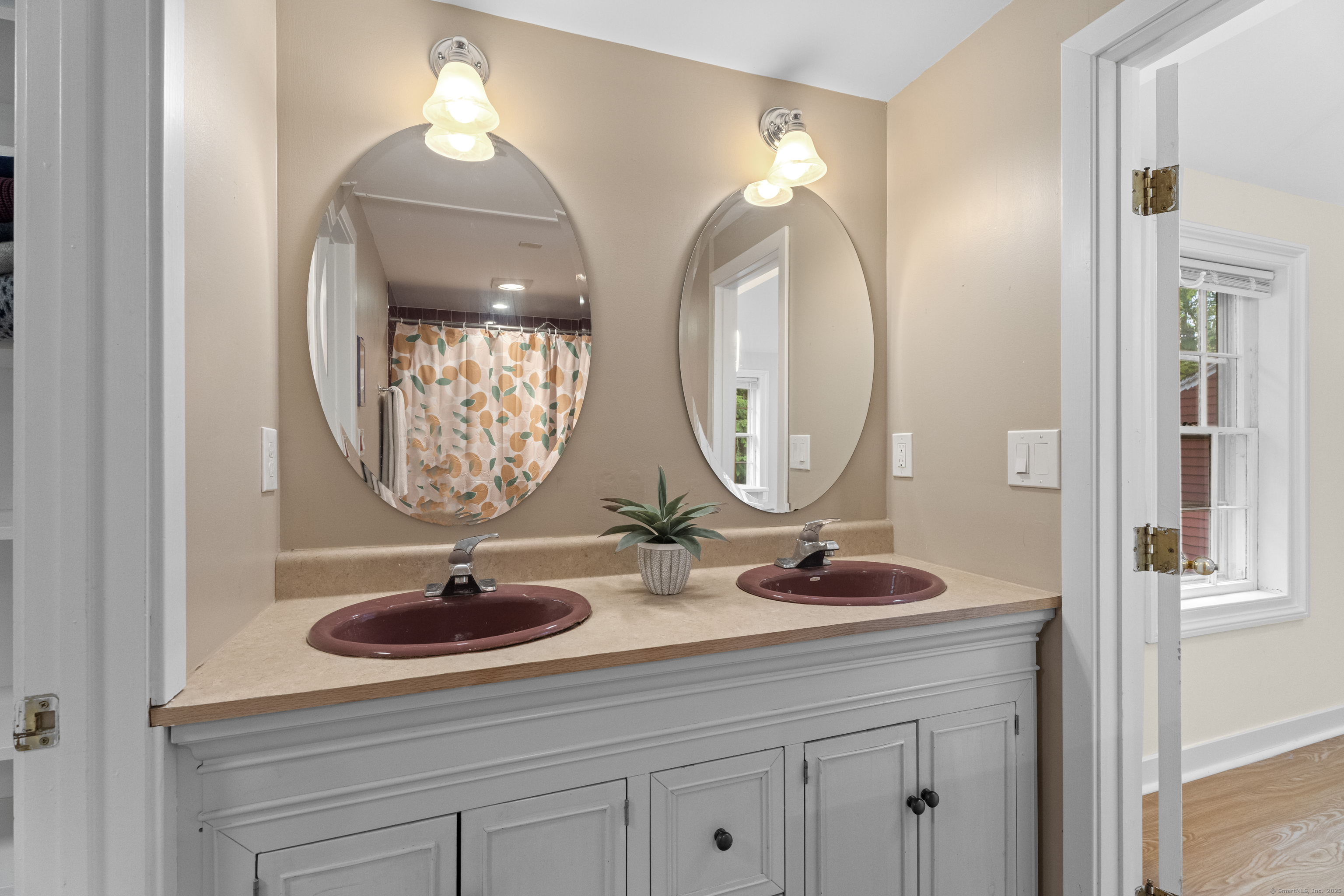 133 Blake Road Hamden, CT 06517 - Photo 23 of 40 a bathroom with a sink and a mirror