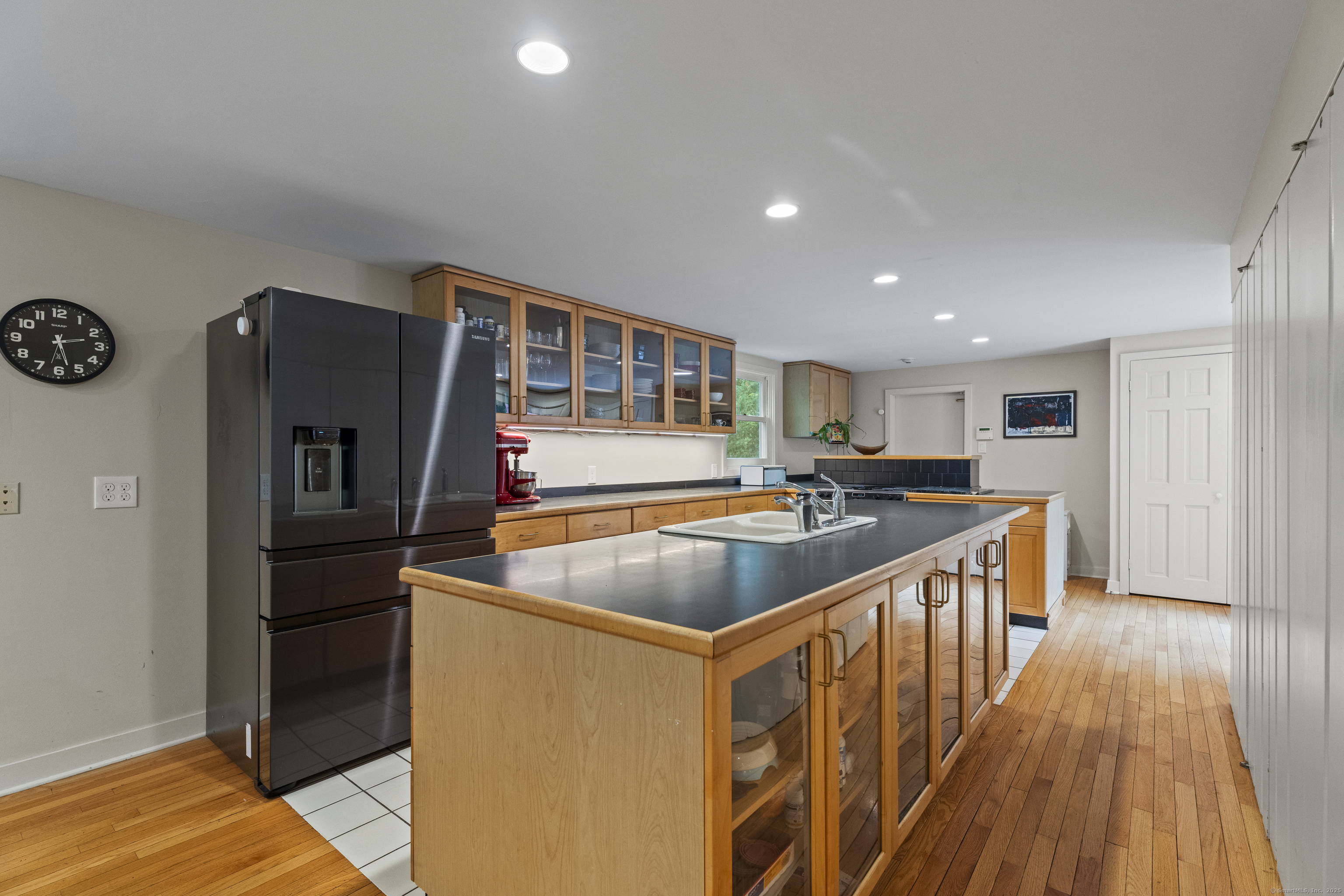 133 Blake Road Hamden, CT 06517 - Photo 9 of 40 a kitchen with stainless steel appliances granite countertop a refrigerator a stove and a wooden floors