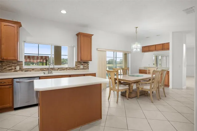 a kitchen with kitchen island granite countertop a sink counter top space and cabinets