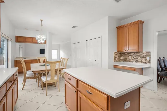 a kitchen with a table chairs and a refrigerator