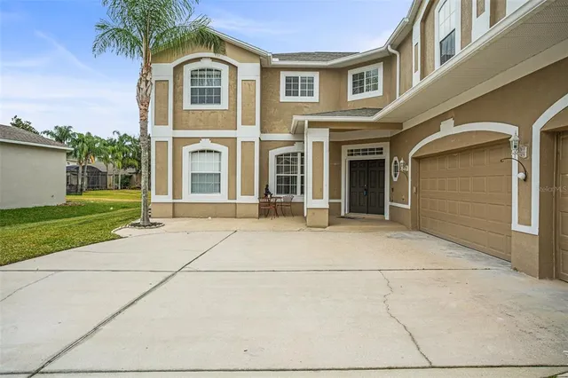 a front view of a brick house with a yard