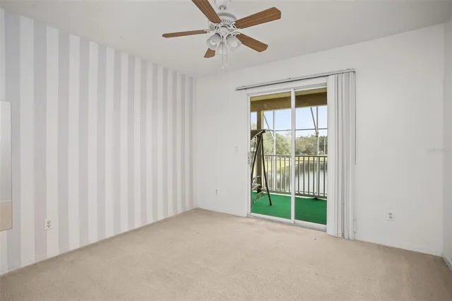 a view of empty room with ceiling fan