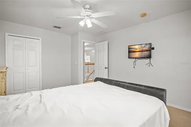 a bedroom with a large bed and a chandelier