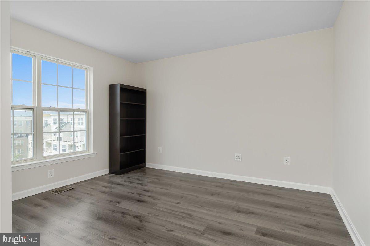 1874 Monocacy View Circle, Unit 28B Frederick, MD 21701 - Photo 19 of 35 an empty room with wooden floor and closet