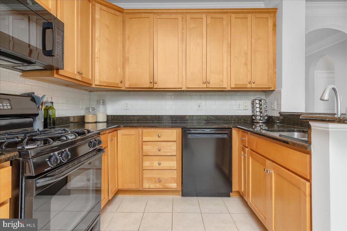 1874 Monocacy View Circle, Unit 28B Frederick, MD 21701 - Photo 8 of 35 a kitchen with stainless steel appliances granite countertop a stove and a microwave
