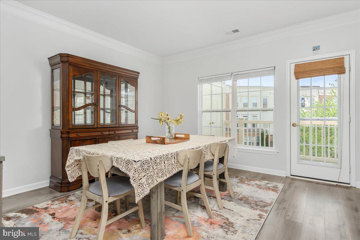1874 Monocacy View Circle, Unit 28B Frederick, MD 21701 - Photo 10 of 35 a view of a dining room with furniture and wooden floor