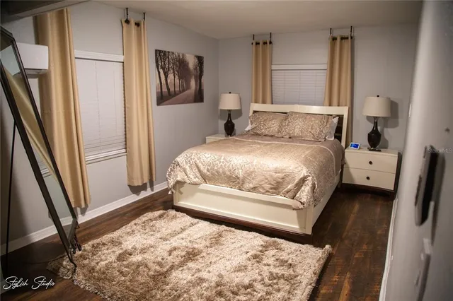 a bedroom with a bed and a rug