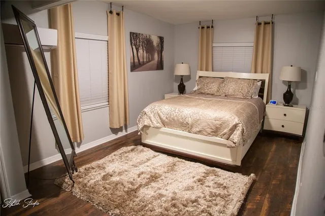 a bedroom with a bed and a large window