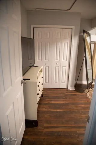a view of a room with wooden floor and a window