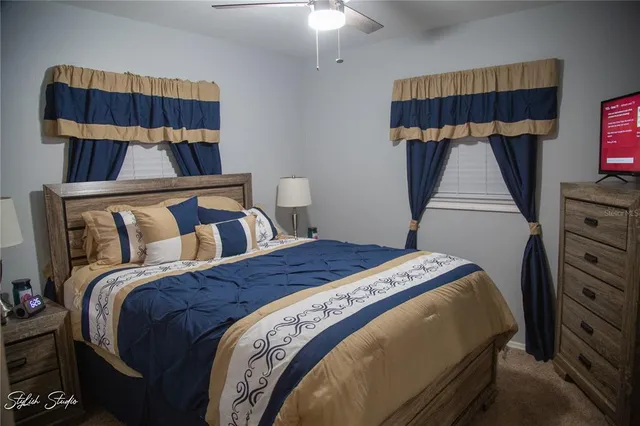 a bedroom with a bed a dresser and a mirror