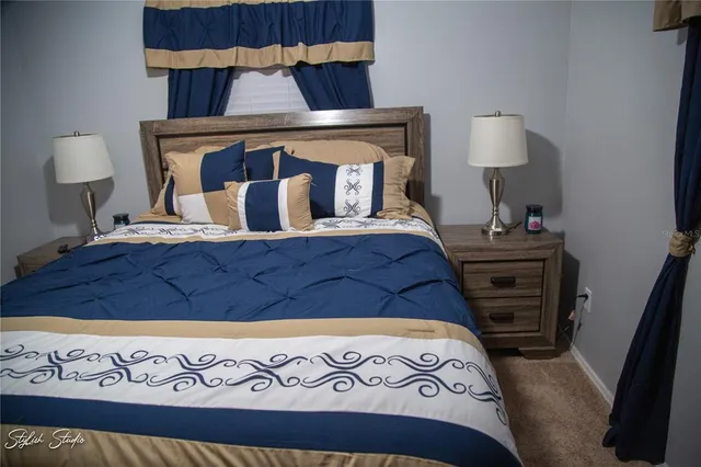 a bedroom with a bed and dresser