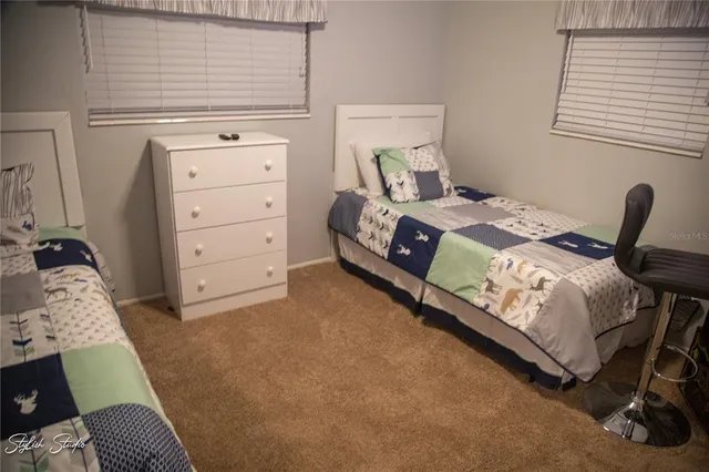 a bedroom with a bed and a chair