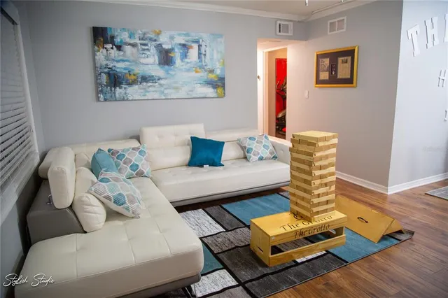 a living room with furniture and a wooden floor