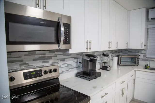 a kitchen with a stove and a microwave