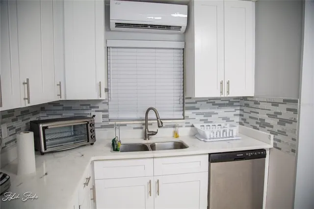 a kitchen with stainless steel appliances granite countertop a sink and cabinets