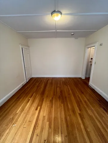 a view of a room with wooden floor