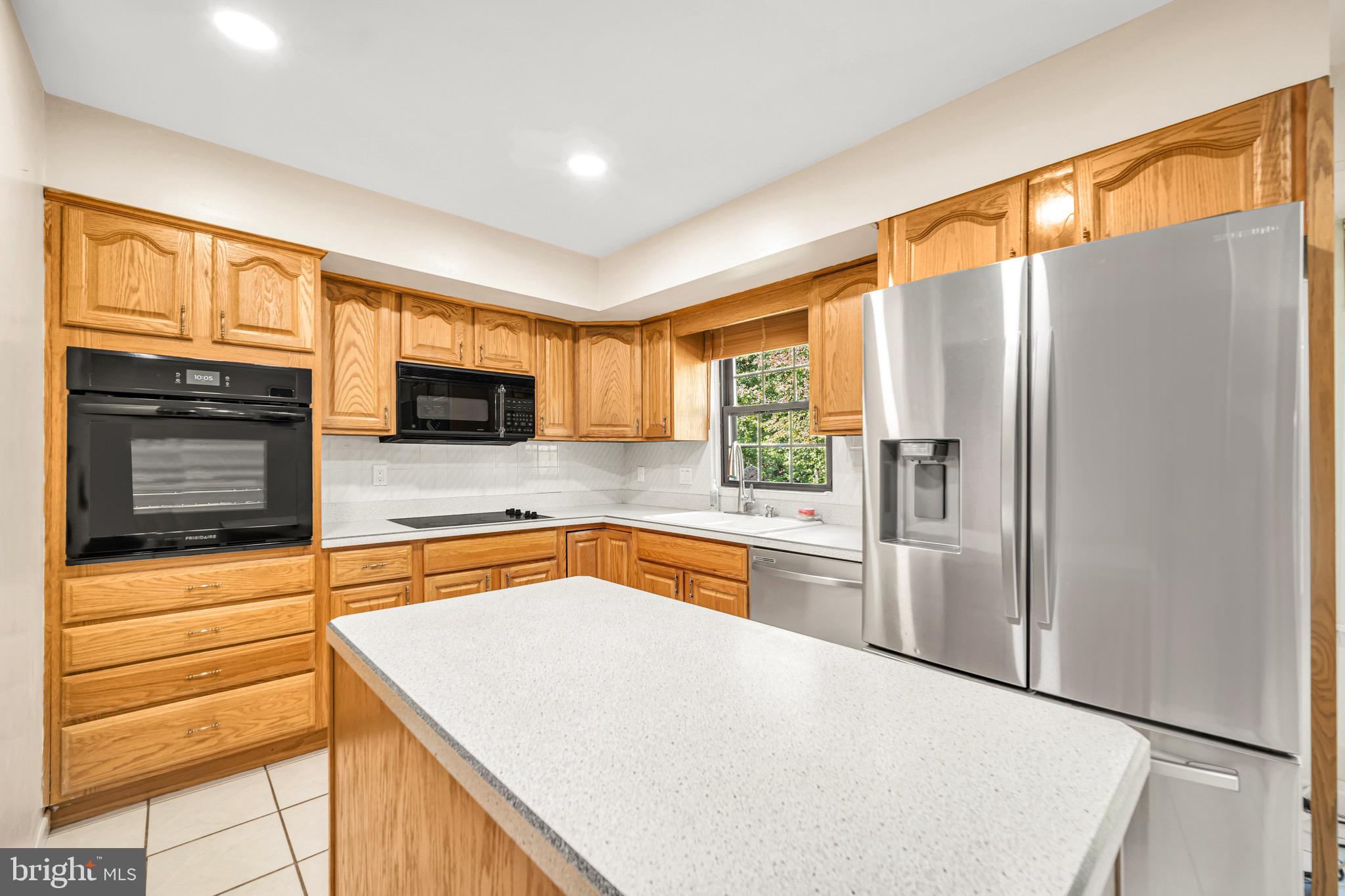 518 Pebble Ridge Court Langhorne, PA 19053 - Photo 11 of 31 a kitchen with stainless steel appliances granite countertop a refrigerator and a stove top oven