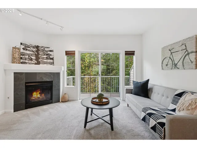 a living room with furniture a window and a fireplace