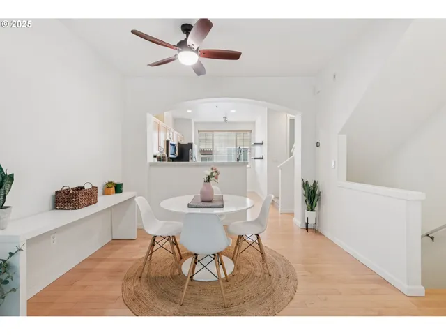a view of a dining room with furniture and a chandelier fan
