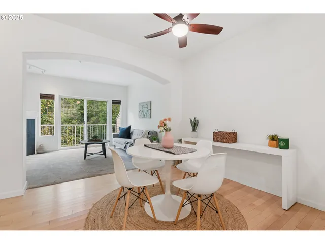 a view of a dining room with furniture and a large window