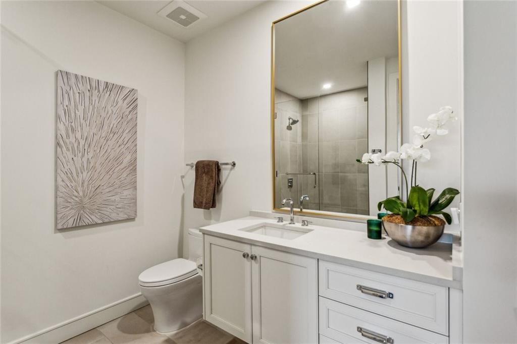 2520 Peachtree Road, Unit 602 Atlanta, GA 30305 - Photo 21 of 45 a bathroom with a toilet a sink and mirror